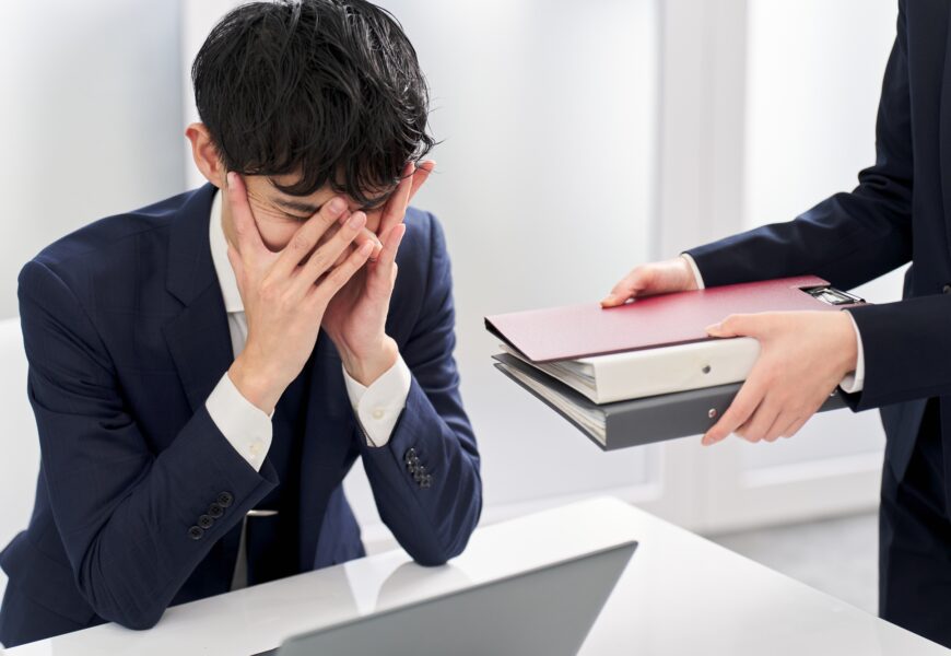 Asian businessman overwhelmed by workload
