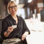 A Confident Businesswoman Smiling Brightly at Her Modern Office Desk Ready for Work and Success