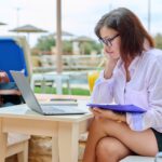 Beautiful business woman in her 40s working on a laptop remotely